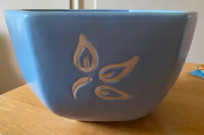 Attractive blue serving bowl (or plant pot). White Petal design embossed on 3 sides. 7” diameter 4”...