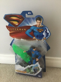 Superman figures, phone, computer, lunch bag