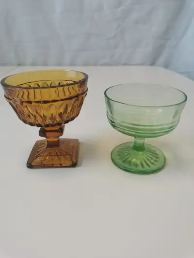 A pair of vintage sherbert dishes in green Depression glass and amber Indiana glass. These dessert b...