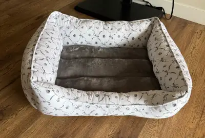 Brand new pet bed too small for my dog and missed the return window White base with cute grey bows a...