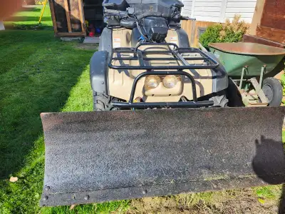 1999 Suzuki big quad very good condition new tires last year,side shifter,up seat , comes with plow...