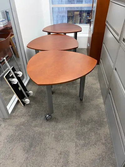 Three wood tables with wheels and a corner table, View more