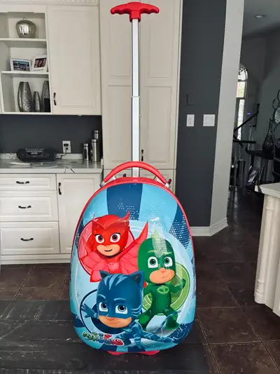 This is a used PJ Masks rolling suitcase, perfect for your little superhero's next adventure. The su...