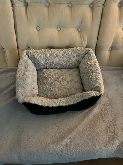 Provide your furry friend with a cosy retreat using this small pet bed, featuring a soft, plush grey...