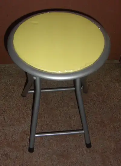 Folding stool with padding. Great as an extra seat when needed. Just a slight cosmetic issue but sti...