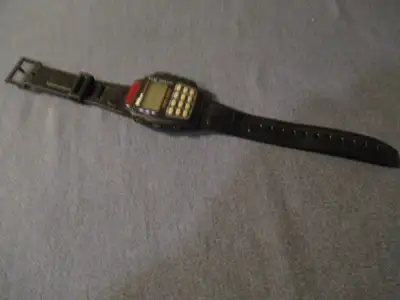 This vintage Wilson Digital TV & VCR REMOTE CONTROLLER WATCH/ALARM dates to the 1990's. Strap is mar...
