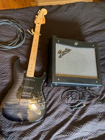 Hello everybody, I have a black tigerstrip maplewood Fender Guitar and Amp for sale with patch chord...