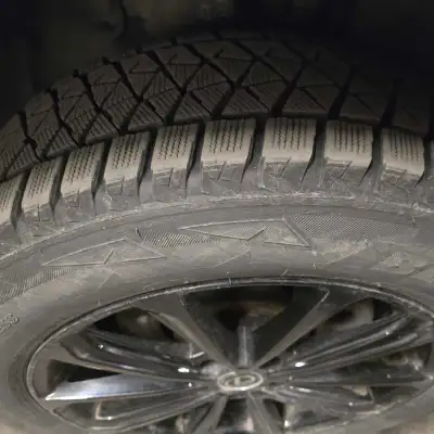 Sturdy Bridgestone Blizzak DM-V2 winter tire and wheel combo. Tire size 235/60R18 107S. Black 18-inc...