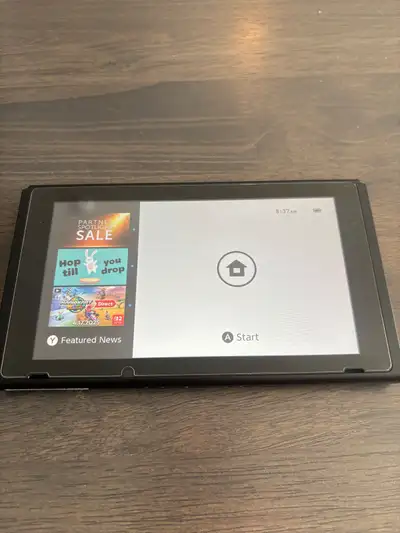 Selling a Nintendo Switch with physical copy of Mario Kart 8. Comes with: -grey joy con controllers...