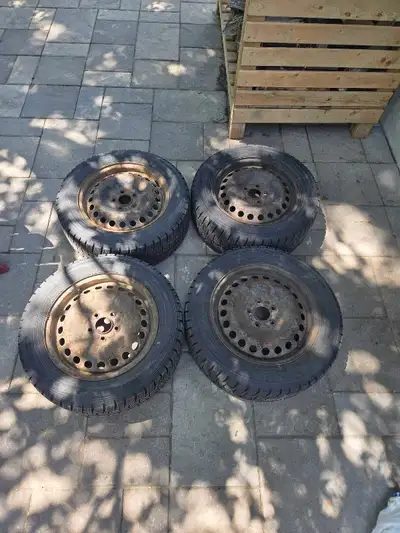 Four Dunlop Winter Maxx tires (215/55R16 97T, with 7 mm of tread remaining) which are mounted on rim...
