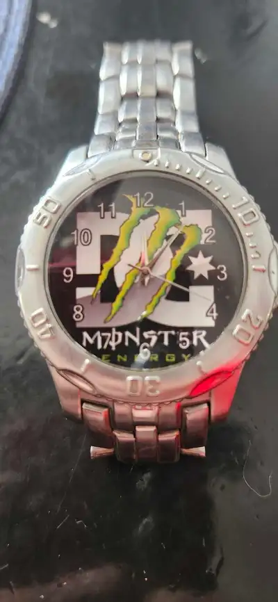 This Fossil watch features a unique custom face with DC and Monster Energy imagery and is in used co...