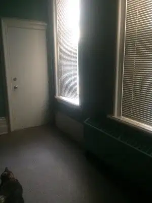 A bright cozy private room, it is very large room with a bookcase and non-working fireplace. It come...