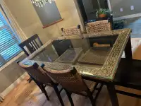 Wicker glass top dining room table with 6 chairs. 