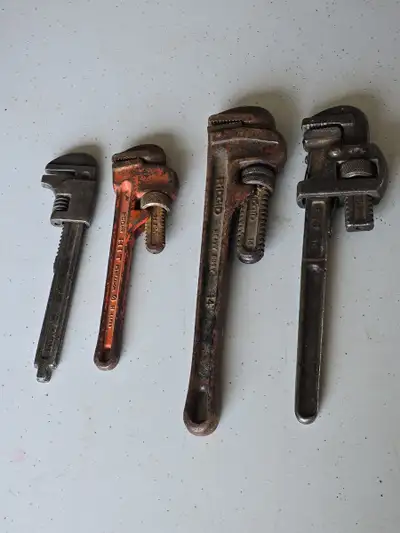 Selling a set of 4 vintage pipe wrenches. All show signs of use and rust but are functional.