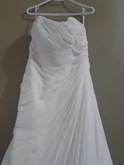 Wedding dress for sale . Size 14. Purchased from Davids Bridal in Winnipeg. Was never worn, just tri...