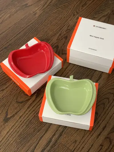 Brand new in box Le Creuset Mini Apple Dishes. Cerise and Palm, 2 of each available. $70/2 or $135/4...