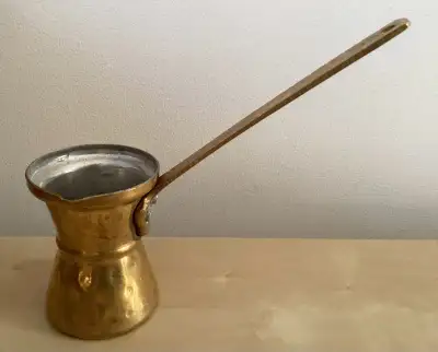 This is a small hammered brass "cezve", which is the Turkish word for a small pot with a long handle...