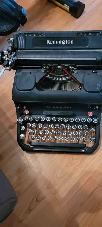 This is a vintage Remington typewriter, a piece of history ready for a new home. It's in used condit...