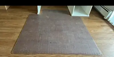 Durable clear plastic chair mat has a textured underside with cleats for grip on carpeted surfaces....