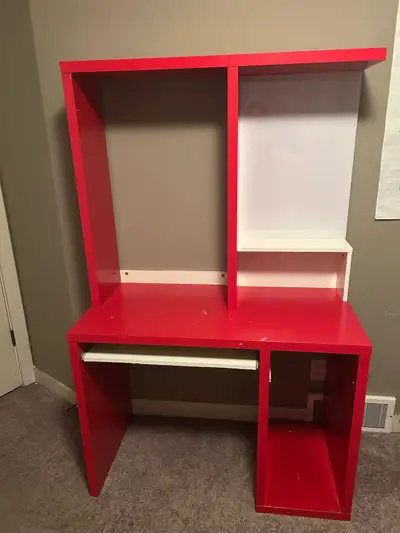 Red computer desk with shelves and pull-out shelf.. Has a white board for writing on. Good condition...