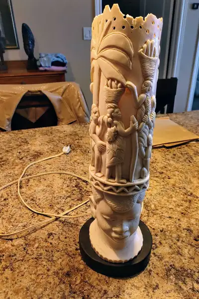 This Vintage Ivory Tusk Lamp is a unique piece, featuring detailed carvings and a sturdy base, perfe...