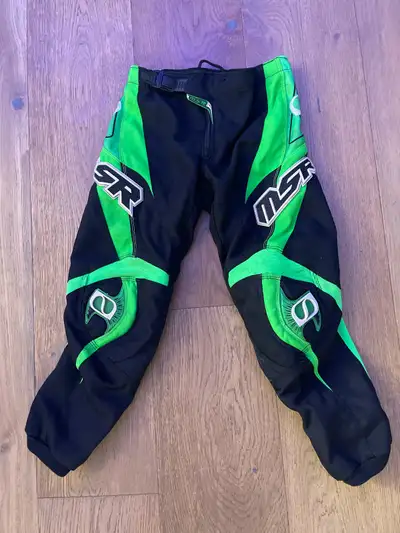 Youth size 5 MSR black and green riding pants! Showing some signs of wear with a small tear (as seen...