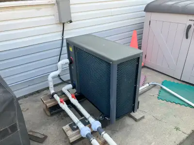 50 000 BTU heat pump pool/hot tub heater. Heater draws heat from air to warm water. Sand pump to pum...