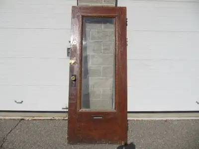 Up for sale is a vintage solid core hardwood door with centre piece glass and all original hardware...