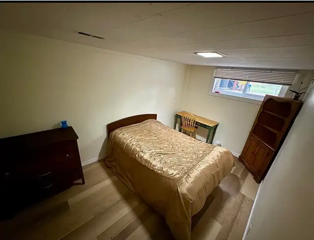 A spacious room fully furnished with a large window for a male