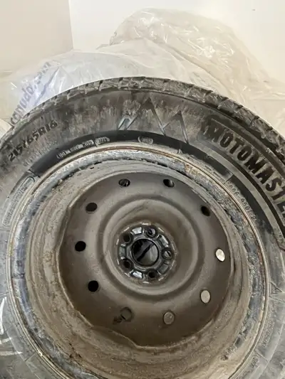 set of four MotoMaster 215/65R16 winter tires mounted on rims
