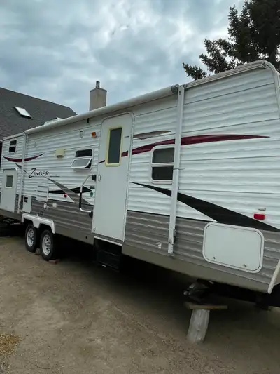 26 foot travel trailer with slide out (dinning and hide a bed couch), stove, fridge (freezer), micro...