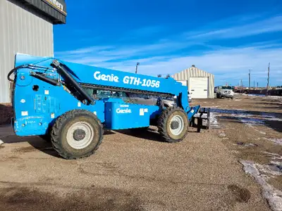 12 Genie 1056 all terrain forklift. 10k lbs lift capacity with a max reach of 56 FT! Has hydraulic o...