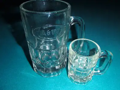 Two embossed A&W mugs One large - $30.00 One "mini" child size- $40.00
