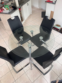 Glass dinning table with 4 leather chairs!!!