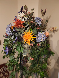 Silk Floral arrangement on wrought iron stand. Over 6' tall.