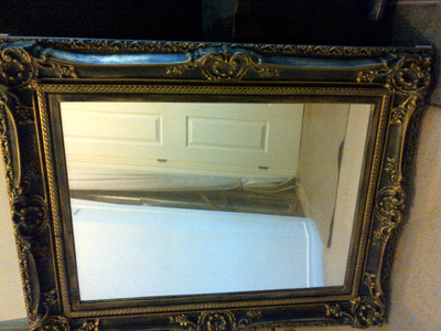 Mirror in ornate metal frame, View more