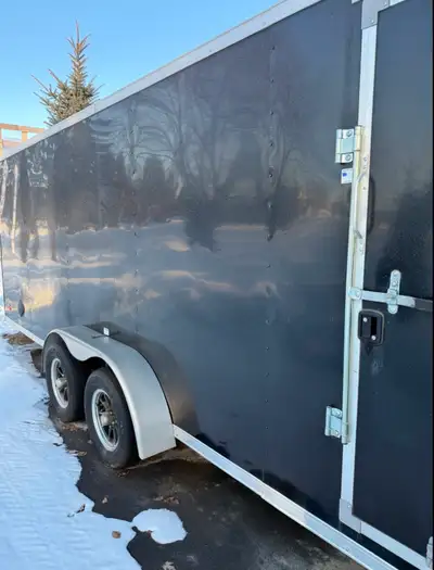 • Tandem axle • Rear ramp • Side man door • Black exterior • Spare tire + bracket included • Full-le...