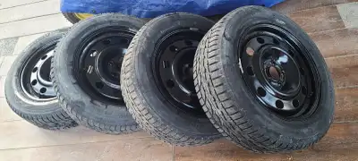 235/55R17 Firestone Winterforce 2 snow tires mounted on black steel rims. Used 2 seasons, surface ru...