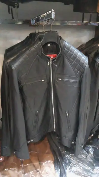 This black real leather motorcycle jacket features a stylish quilted shoulder design and durable zip...
