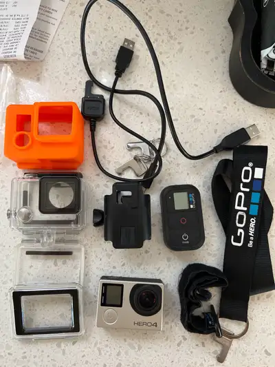GoPro HERO 4 with accessories shown. Smart remote and cases, charging cables etc. Pickup in Brooklin