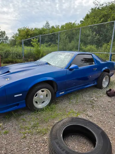 This is a used 1984 Chevrolet Camaro RS, a classic sports car. It features a sleek design and powerf...