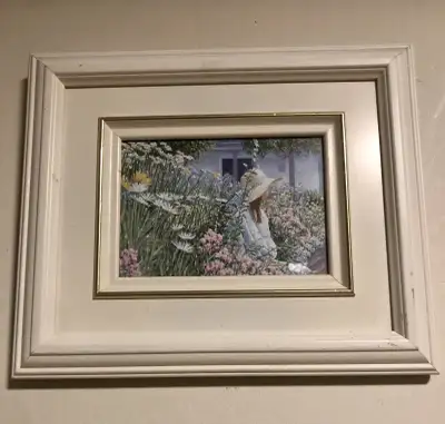 Frame print by Elizabeth fisher depicting a young girl sitting in a garden. Framed in a simple off w...