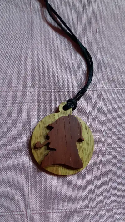 Very unusual Sherlock Holmes profile image pendant, carved out of exotic hardwoods, on a silky black...