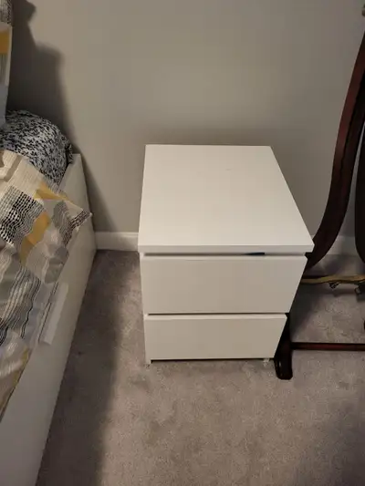 This IKEA white 2-drawer nightstand offers a clean, modern storage solution for your bedroom and is...