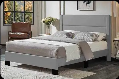 Elevate your bedroom with this stylish queen-size upholstered bed frame, featuring a sleek grey fini...