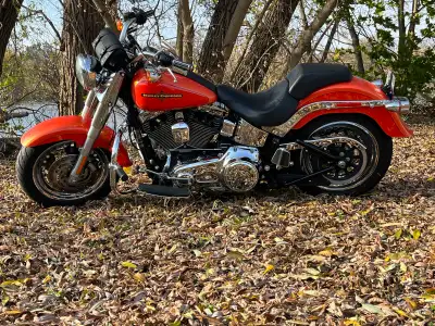 For sale Beautiful 2012 HD Fat Boy. Only 2 owners and only 13,000 km on it. Rare Tequila Sunrise pai...