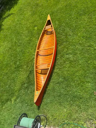 This is a beautiful museum piece Cedar Strip Chestnut Canoe featuring classic wood construction with...