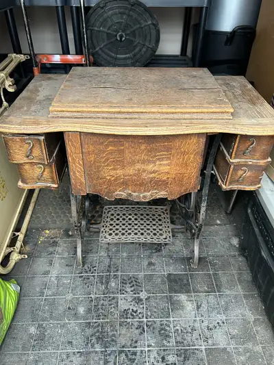 Antique treadle sewing machine and cabinet.
