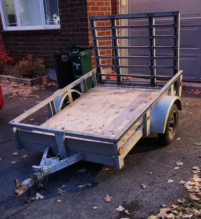 Selling a used utility trailer in solid, reliable working condition. Dimensions are 5 ft wide and 7...