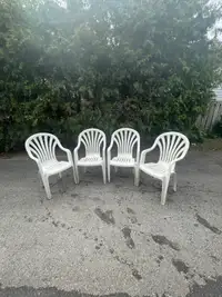 Outdoor plastic chairs, 4 white stackable plastic chairs all $30